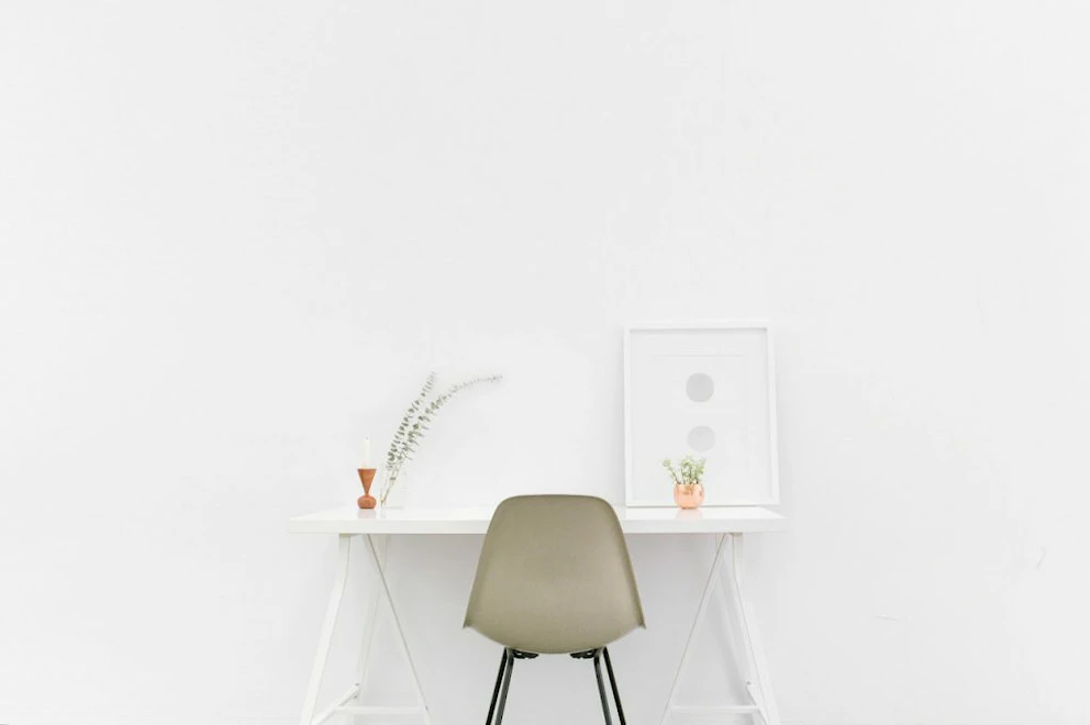Un bureau blanc minimaliste au milieu d'une pièce vide