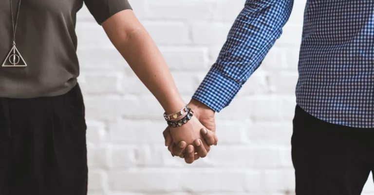 A man and a woman are holding hands.