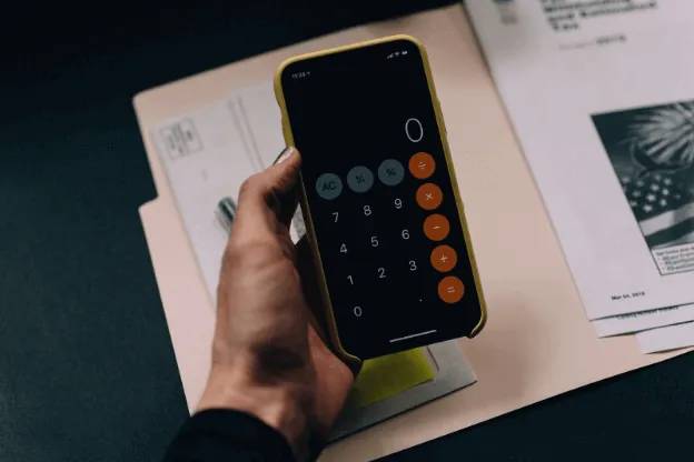 Man doing calculations on his mobile phone.