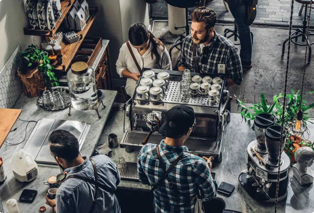 A couple orders a drink at a barista bar