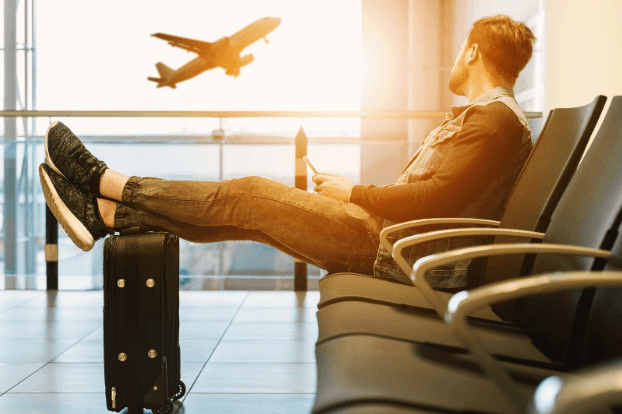 Man who is about to travel with only one luggage on his feet.