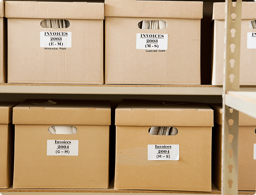 Cardboard boxes on shelves containing invoices