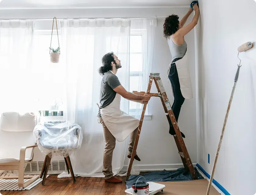Couple repeignant un mur de leur salon