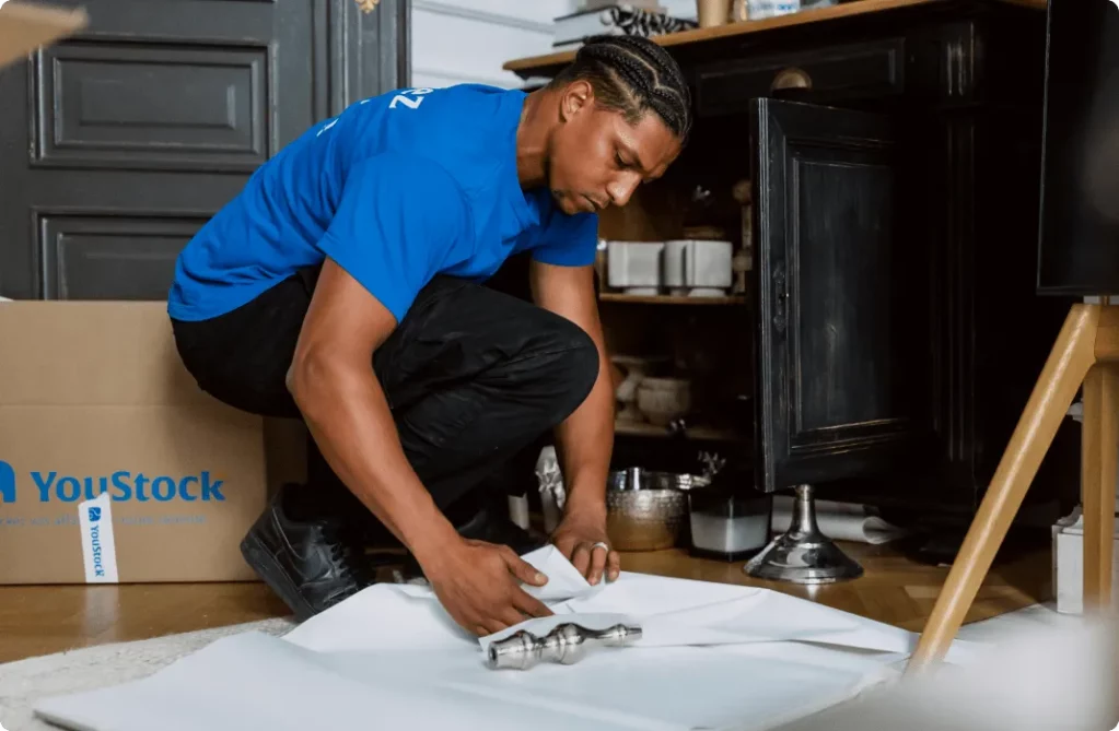 A YouStock mover packs crockery for storage