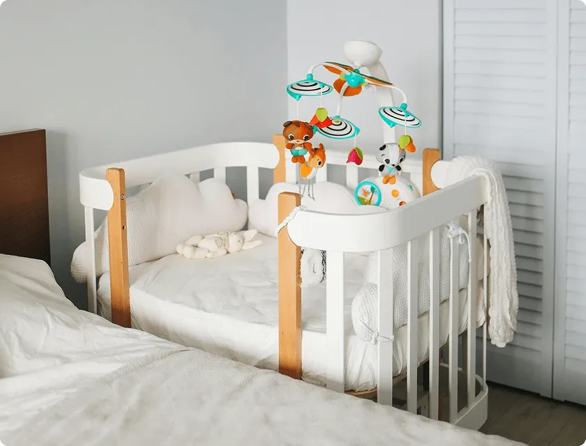 Cot next to a parent's bed