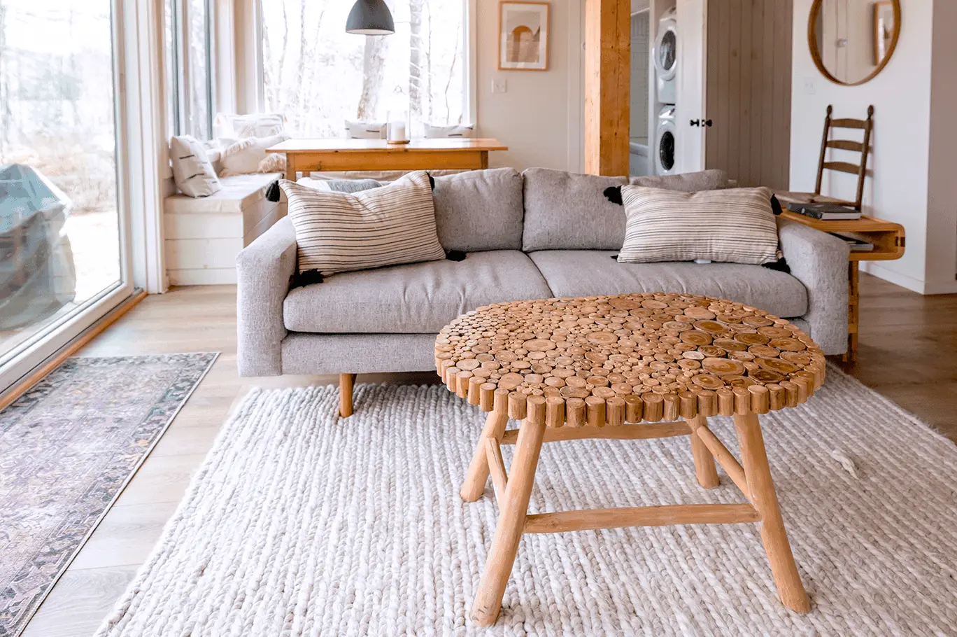 Canapé et table basse placés sur un tapis blanc tressé