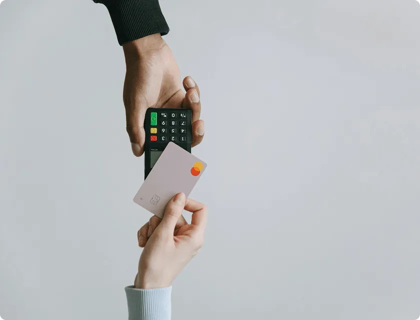 A person places a card on a payment terminal.
