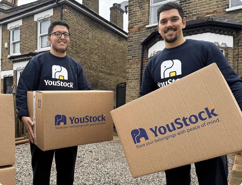 Two YouStock movers holding storage boxes