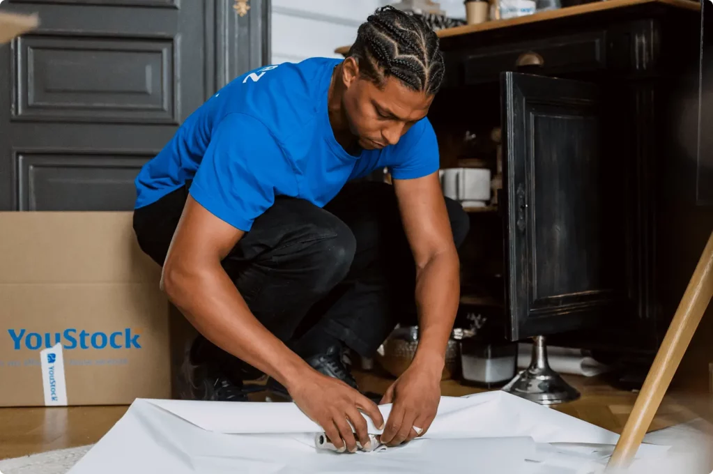 A YouStock mover packs crockery for storage