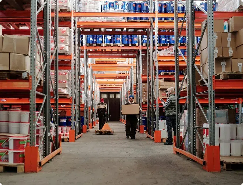 3 employees working in a storage warehouse