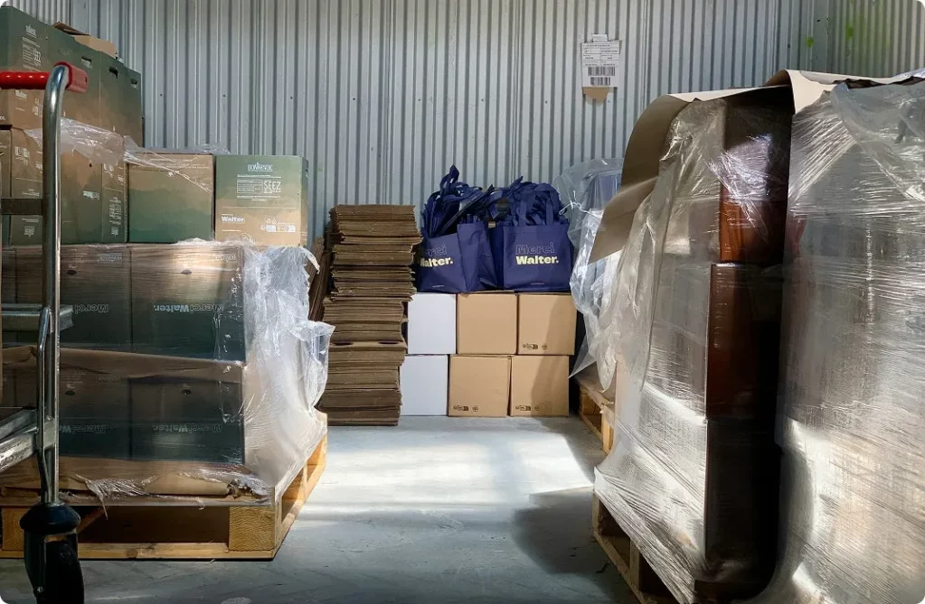 Boxes and bags stacked on pallets in a storage space