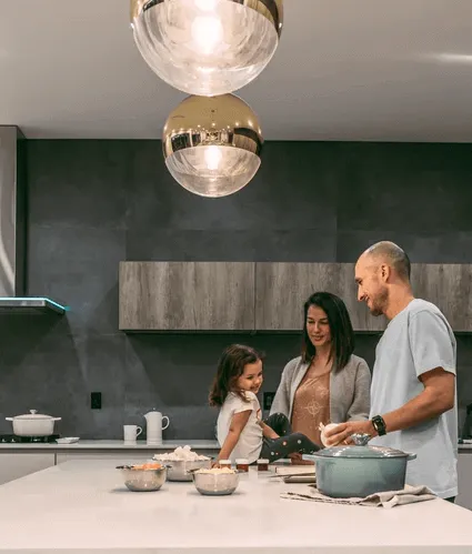 Happy family in the kitchen of their house.