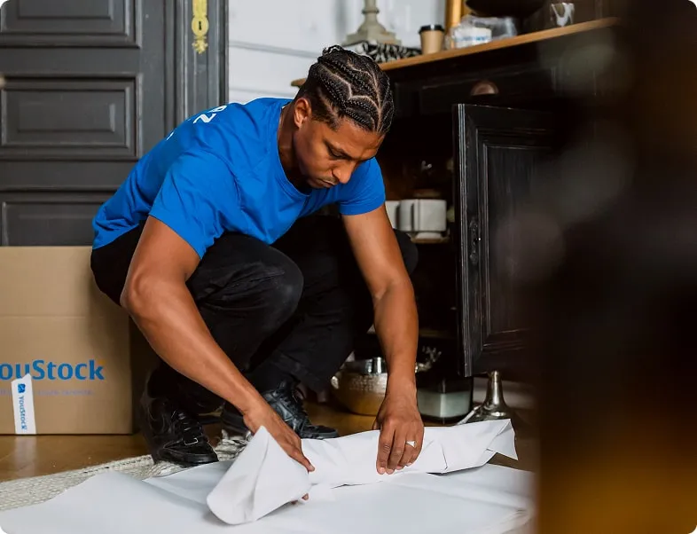 A YouStock mover packs and protects dishes for moving