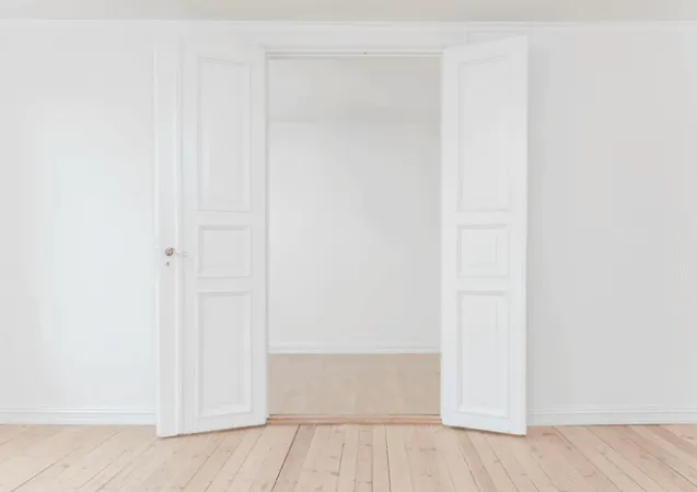 Empty Room With Two White Doors