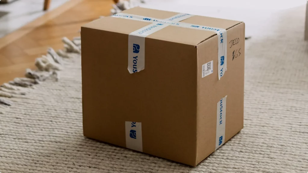 Zoom in on a cardboard box on the floor, ready for storage.