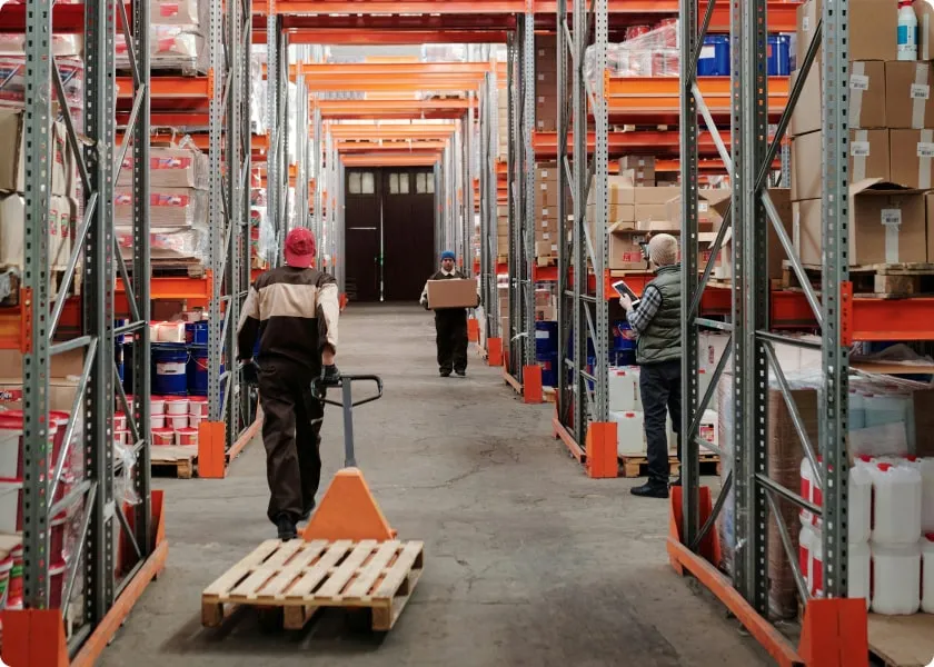 3 men work in a storage and logistics warehouse