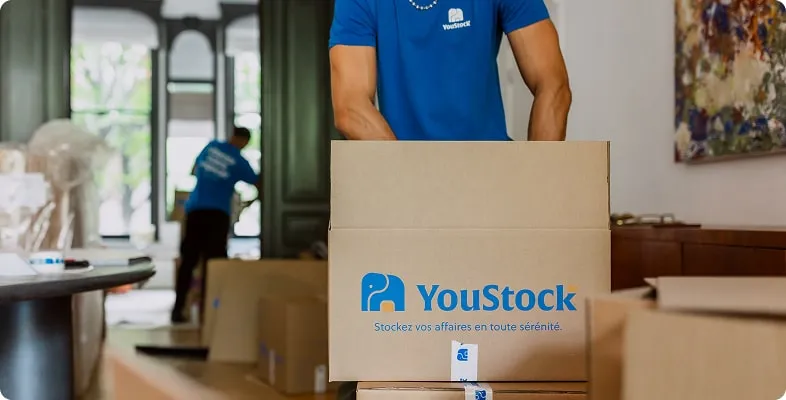 A YouStock professional packs items into boxes before storing them.