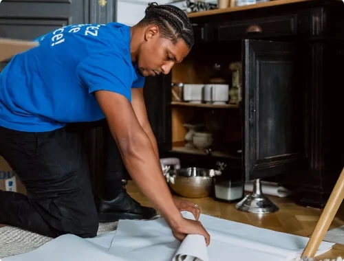 A professional YouStock mover carefully packs dishes