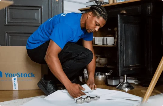 A YouStock mover packs crockery for storage
