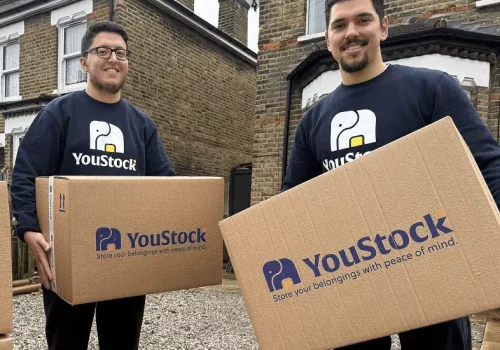 Two YouStock movers holding storage boxes